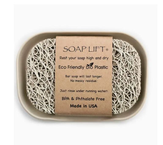 A soap saver pad inside a tray with an informational card detailing the product's benefits, including eco-friendly design, mess reduction, and being bpa & phthalate free, all made in the usa.